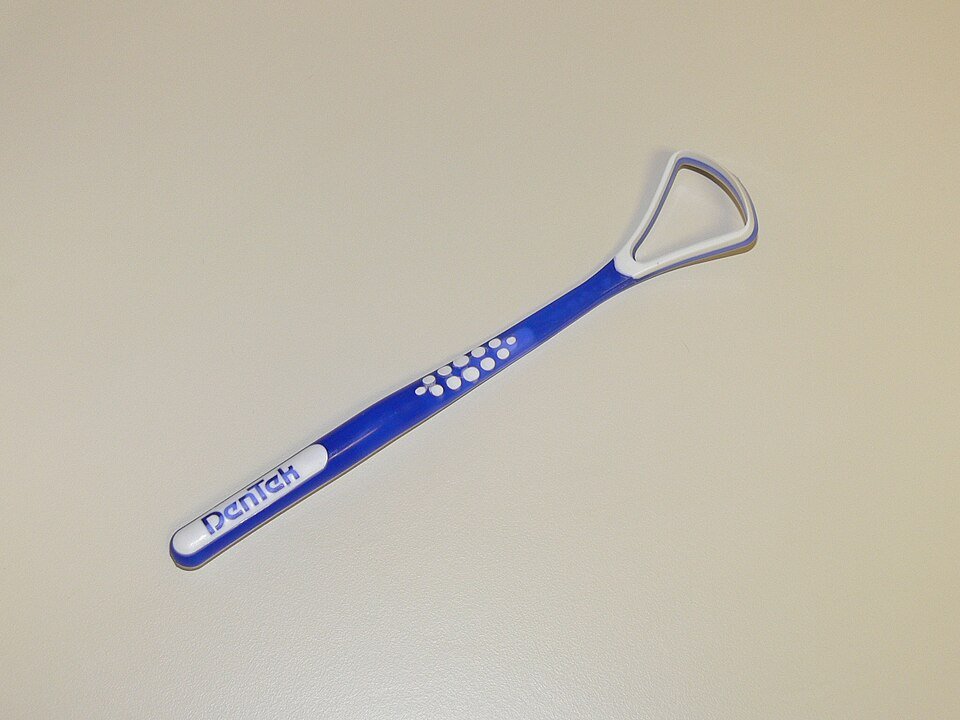 A metal tongue scraper, the tool used for mechanical removal of tongue coating