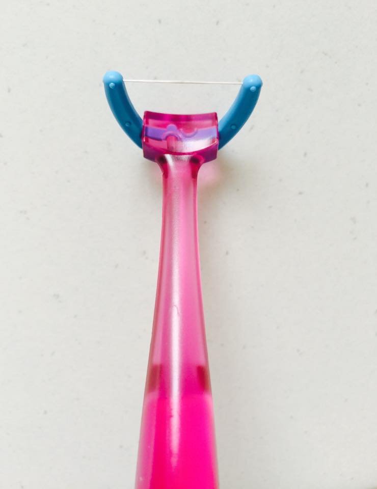 A Y-shaped dental floss pick, a gentler flossing option for irritated or bleeding gums